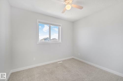 Room featuring light gray carpeting and white baseboards - 614 Mcdonough Link, Edmonton, AB 