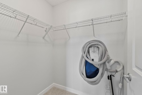 Corner closet featuring wire shelving, white wall paint, white baseboards, and carpet flooring - 614 Mcdonough Link, Edmonton, AB 