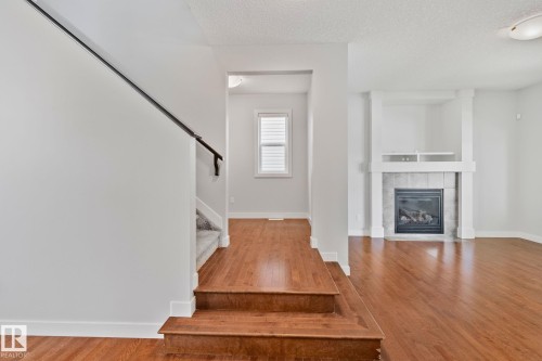 Warm wood-finish flooring throughout the main level - 614 Mcdonough Link, Edmonton, AB 