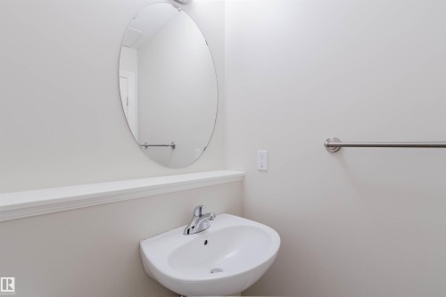 Wall-mounted oval mirror with chrome-finish vanity light - 1131 177 Street, Edmonton, AB 