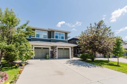 Two-story duplex featuring horizontal siding and stone veneer accents - 1131 177 Street, Edmonton, AB 