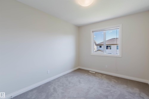Neutral-toned walls and plush gray carpeting define this interior space - 1131 177 Street, Edmonton, AB 
