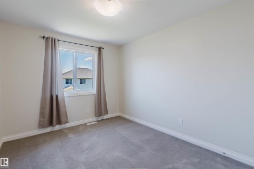 Neutral color palette featuring light gray walls, white trim, and gray carpeting - 1131 177 Street, Edmonton, AB 