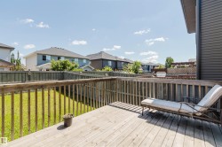 Expansive wooden deck featuring sturdy railings and a spacious surface - 