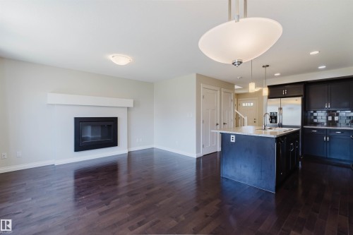 Open-concept living space with dark wood-finish flooring - 1131 177 Street, Edmonton, AB 
