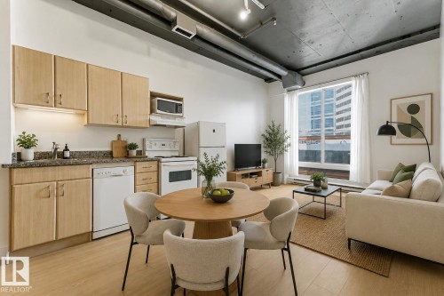 Open-concept living area with wood-finish flooring - 404 10024 Jasper Avenue, Edmonton, AB 