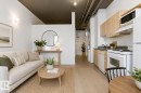 Open-concept living space with light wood-finish flooring - 404 10024 Jasper Avenue, Edmonton, AB 