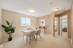 Carpeted room with a double-paned window, neutral wall tones, and overhead lighting - 