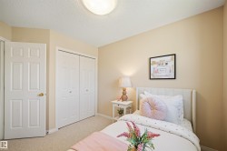 Carpeted room with a textured ceiling and neutral-toned walls - 