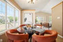 Dining area featuring a large multi-pane window, vaulted ceiling, and neutral wall tones - 7838 Schmid Place Nw, Edmonton, AB 