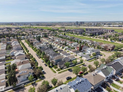 Aerial perspective of a residential neighborhood featuring detached homes with varied rooflines and a mix of exterior finishes - 7838 Schmid Place Nw, Edmonton, AB 