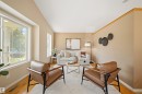 Living area featuring warm neutral wall tones and wood-finish flooring - 7838 Schmid Place Nw, Edmonton, AB 