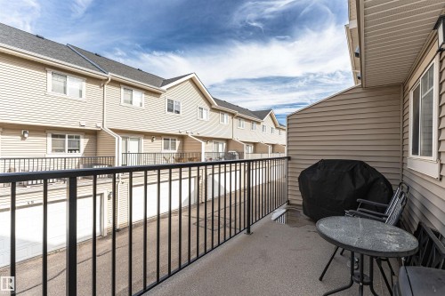 Exterior balcony with concrete flooring, black metal railing, and attached exterior lighting fixture - 35 675 Albany Way, Edmonton, AB 
