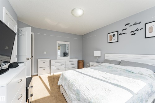 Carpeted bedroom featuring light gray wall paint and white trim - 35 675 Albany Way, Edmonton, AB 