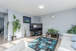 Living area featuring light wood-finish flooring and a neutral wall color - 