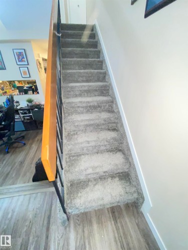 Stairway featuring wood finished floors and baseboards - 11176 83 Avenue, Edmonton, AB - Indoor Photo Showing Other Room