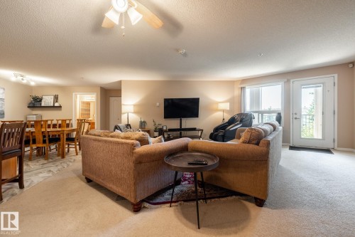 Open-concept living space featuring neutral paint, soft carpeting, and a ceiling fan - 330 1520 Hammond Gate Gate, Edmonton, AB 