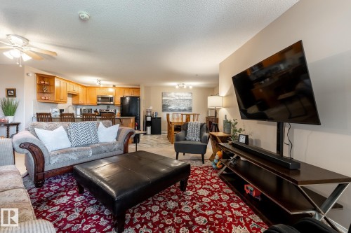 Open-concept living area with a kitchen, dining space, and living room - 330 1520 Hammond Gate Gate, Edmonton, AB 