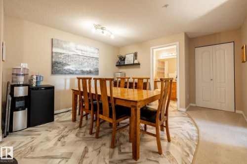 Dining area featuring wood-finish flooring, neutral wall tones, and a track lighting fixture - 330 1520 Hammond Gate Gate, Edmonton, AB 