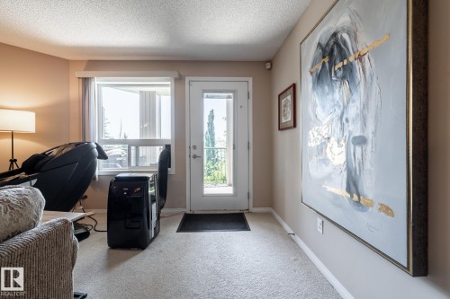 Access to an exterior balcony via a white-framed glass door - 330 1520 Hammond Gate Gate, Edmonton, AB 