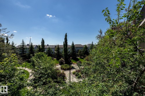 Lush green landscaping with mature trees and paved walking paths - 330 1520 Hammond Gate Gate, Edmonton, AB 