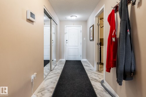 Entryway featuring marble-look flooring, a flush-mount ceiling light, and a built-in thermostat - 330 1520 Hammond Gate Gate, Edmonton, AB 