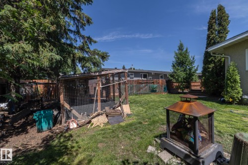 Expansive backyard featuring a green lawn, mature trees, and a privacy fence - 3608 44 Street, Leduc, AB 
