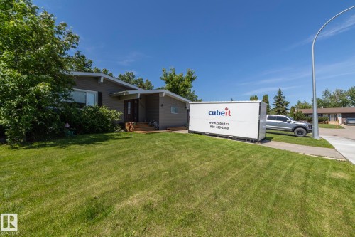 Single-story exterior featuring a gray siding facade with white trim - 3608 44 Street, Leduc, AB 