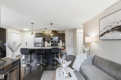 Open-concept living area featuring dark wood-finish flooring - 