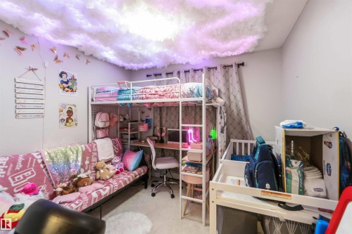 White metal loft bed with integrated desk, complemented by a ceiling feature with integrated lighting - 244 1196 Hyndman Road, Edmonton, AB 