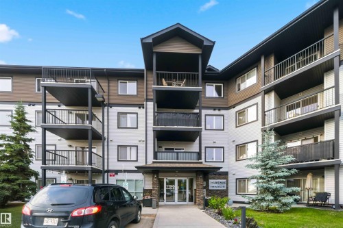 Multi-story residential building featuring light grey and brown siding - 244 1196 Hyndman Road, Edmonton, AB 