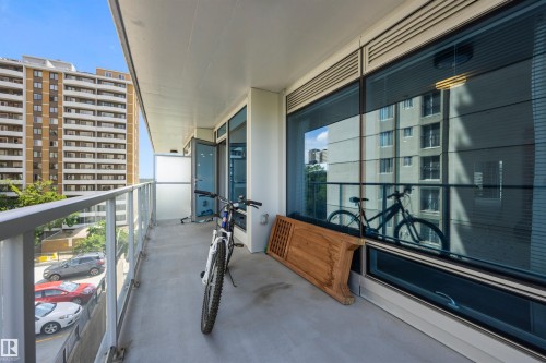Private balcony with concrete flooring, glass panel railing, and white frame - 802 9720 106 Street, Edmonton, AB 
