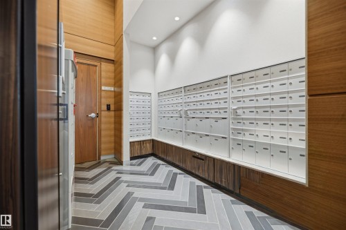 Modern mailroom featuring an extensive bank of individual mailboxes - 802 9720 106 Street, Edmonton, AB 