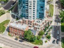 Multi-story building featuring a glass facade and brick lower levels - 802 9720 106 Street, Edmonton, AB 