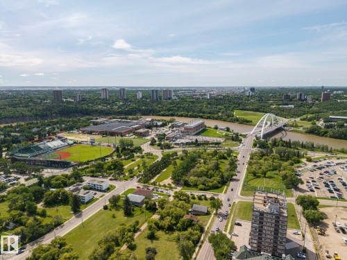 Expansive aerial perspective capturing a city skyline, a river, and a large green baseball stadium - 802 9720 106 Street, Edmonton, AB 