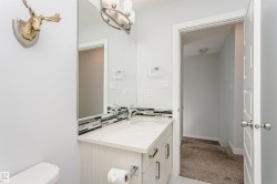 Vanity with undermount sink, countertop, and mosaic tile backsplash - 