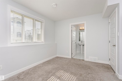Carpeted room with recessed lighting and a window featuring horizontal blinds - #55 723 172 St Sw, Edmonton, AB - Indoor Photo Showing Other Room
