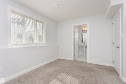 Carpeted room with recessed lighting and a window featuring horizontal blinds - 