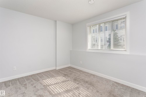 Room featuring light gray walls, gray patterned carpeting, and white trim - #55 723 172 St Sw, Edmonton, AB - Indoor Photo Showing Other Room