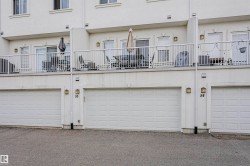 Exterior facade with private garages and individual upper-level balconies featuring white railings - 