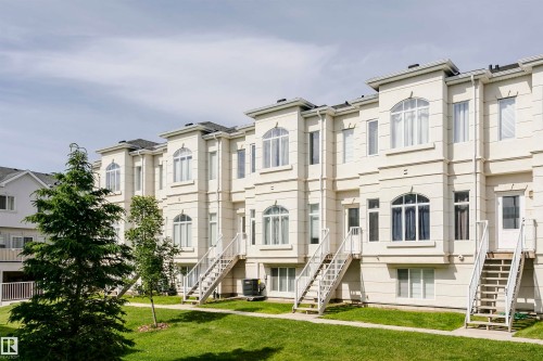 Row of multi-story townhomes featuring light-toned exteriors with decorative architectural accents - #55 723 172 St Sw, Edmonton, AB - Outdoor With Facade