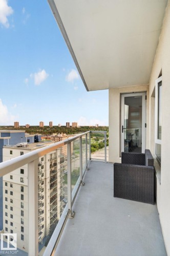 Private balcony featuring a glass railing, concrete flooring, and a sliding glass door entry - 1504 9720 106 Street, Edmonton, AB 