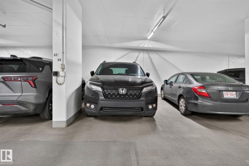 Underground parking garage featuring concrete flooring and white painted walls - 1504 9720 106 Street, Edmonton, AB 
