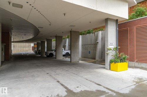 Covered parking structure featuring concrete columns and a curved ceiling design - 1504 9720 106 Street, Edmonton, AB 