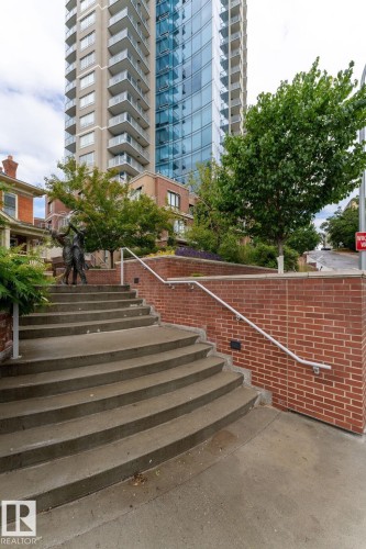Modern high-rise residential building featuring a curved glass facade and individual balconies - 1504 9720 106 Street, Edmonton, AB 