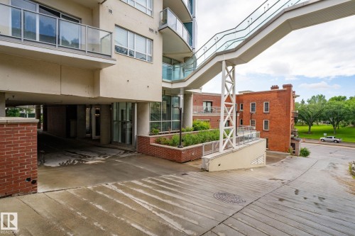 Contemporary building facade featuring multiple balconies with glass railings - 1504 9720 106 Street, Edmonton, AB 