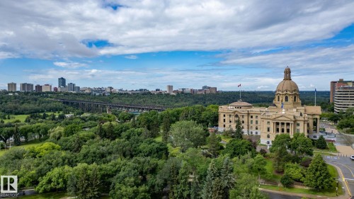 Expansive urban landscape featuring a prominent domed building with classical architecture, surrounded by mature trees and lush green parkland - 1504 9720 106 Street, Edmonton, AB 
