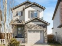 Two-story residence featuring a stone facade, a single-car garage, and a covered entryway - 17171 38 Street, Edmonton, AB 