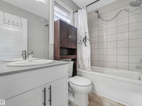Bathroom featuring a white vanity with a gray countertop, an undermount sink, and chrome fixtures - 17171 38 Street, Edmonton, AB 