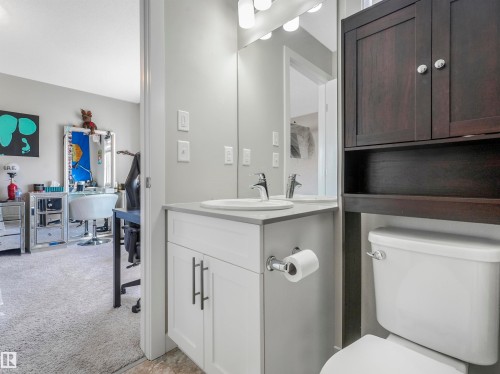 Bathroom featuring a white vanity with a light gray countertop, undermount sink, and chrome faucet - 17171 38 Street, Edmonton, AB 